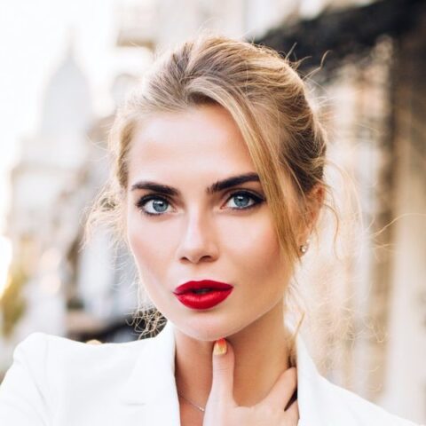 portrait-fashion-model-walking-in-city-she-wears-white-jacket-looking-to-camera-e1647915541635.jpg